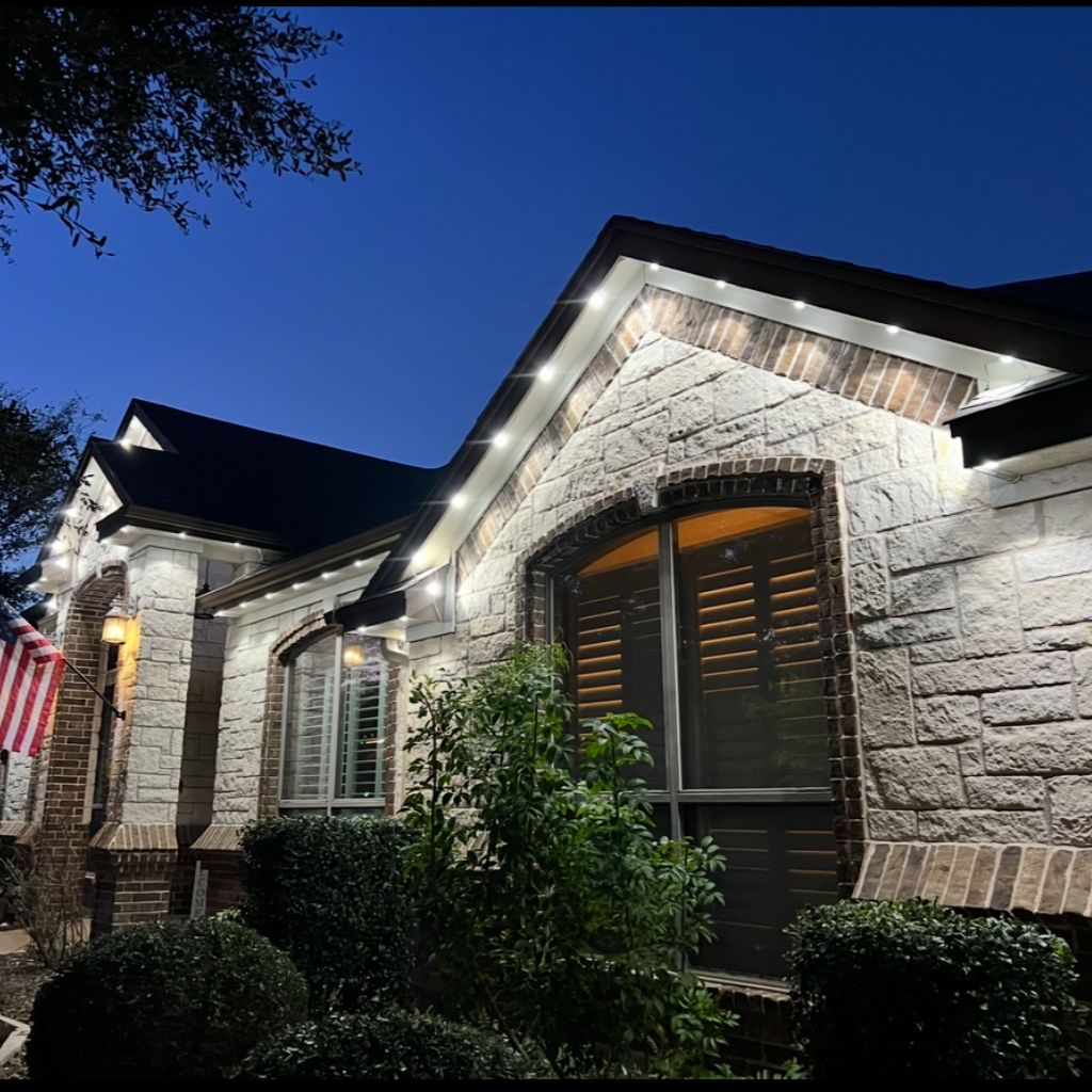 Stone home with clean warm white permanent LED accent lighting