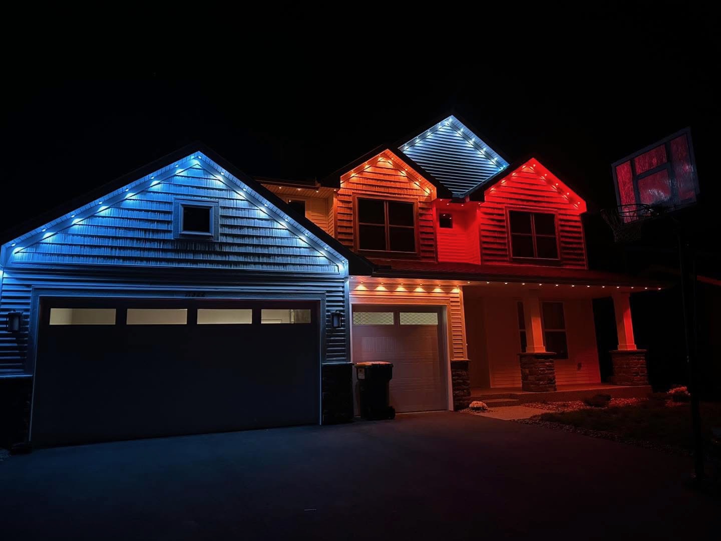 Home with blue, white, and red permanent LED lighting at night